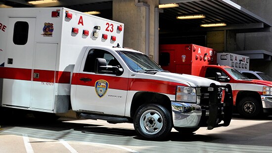 Emergency vehicles parked in a garage bay