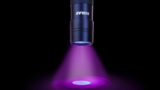 Flashlight sitting next to two tubes of DAZO fluorescent marking gel